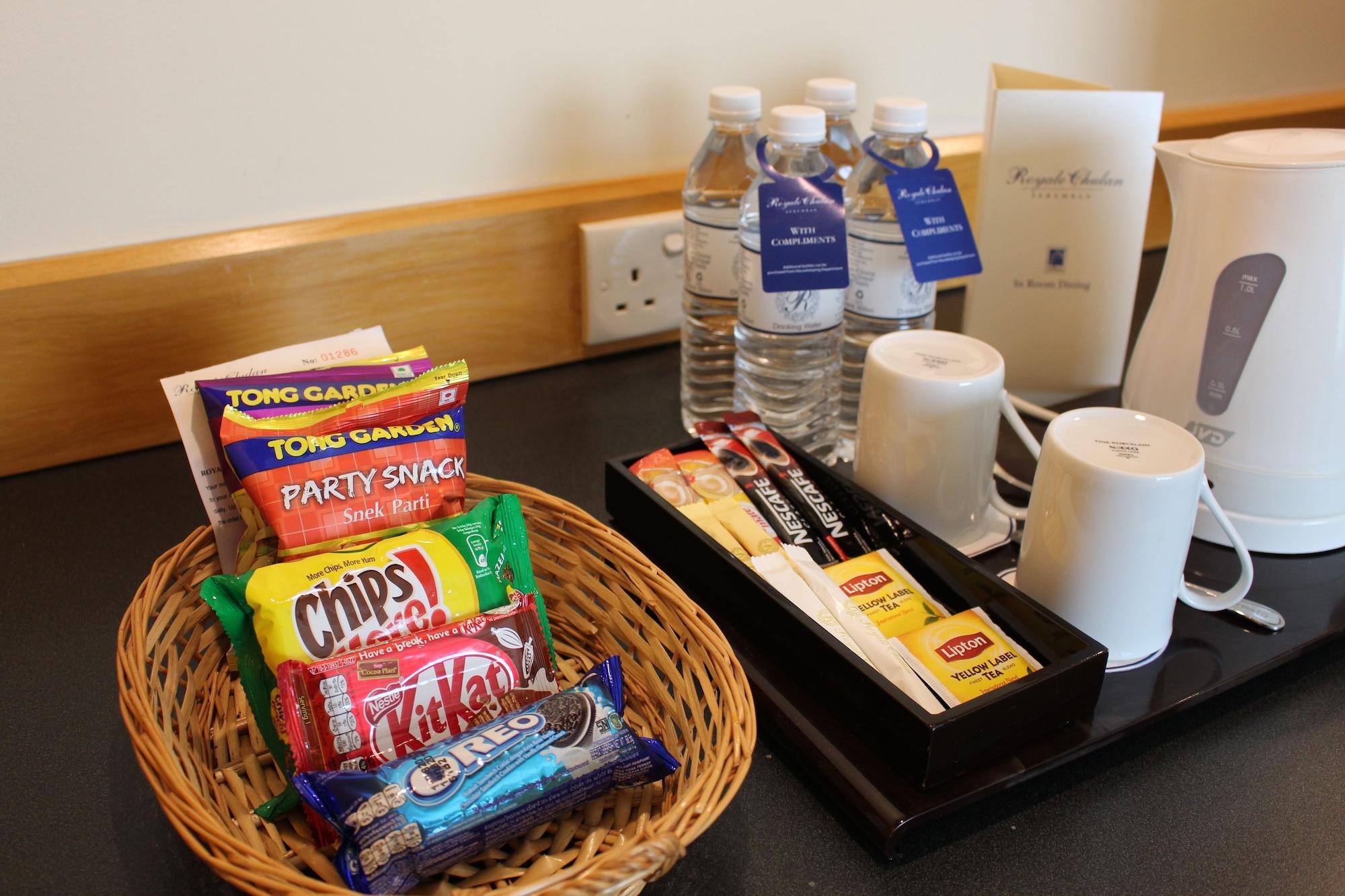 Royale Chulan Серембан  Экстерьер фото A selection of snacks and bottled water in a hotel room